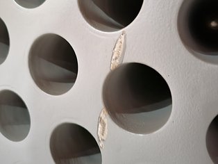 Damaged Si 570 AR lining with the exposed substrate before restoration using Ceramoclad 221