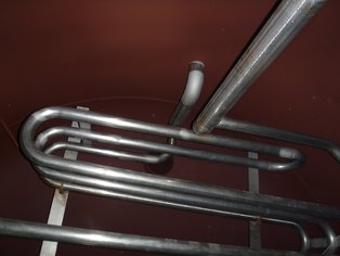 Partial inside view of the high temperature Condensate Tank lined with Si 57 EG showing a stainless steel heating coil 