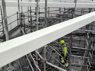 Removing internal scaffolding after lining the tank's internal walls and completing the QC inspection